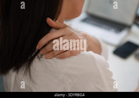 Office worker neck and back pain from prolonged computer work Stock Photo