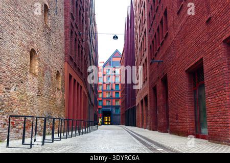 Narrow Urban Alleyway Between Red Brick Buildings, the rebuilt Granary Island in Gdansk, Poland Stock Photo