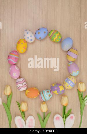 Easter Circle. Decorated eggs arranged in a circle with tulips on wooden background. Stock Photo