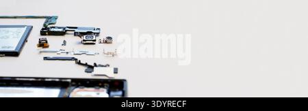 Disassembled smartphone components on a white background. Electronic parts, battery, camera modules, and motherboard displayed for repair or recycling Stock Photo