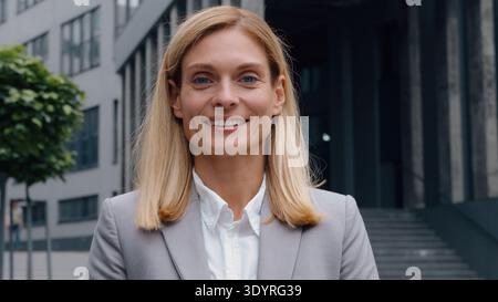Female business portrait in city adult woman businesswoman smiling carefree middle-aged company CEO happy smile posing in downtown near office Stock Photo