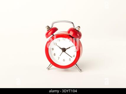 Front of red alarm clock isolated on white background. Stock Photo