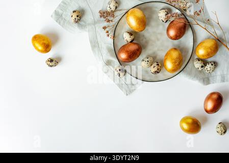 Golden and bronze Easter eggs in a grey plate Stock Photo