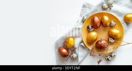 Golden and bronze Easter eggs in a orange plate Stock Photo
