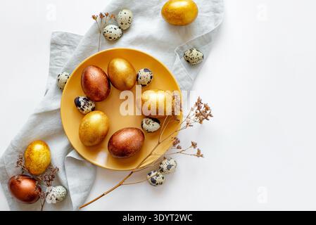 Golden and bronze Easter eggs in a orange plate Stock Photo