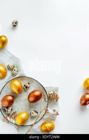 Golden and bronze Easter eggs in a grey plate Stock Photo