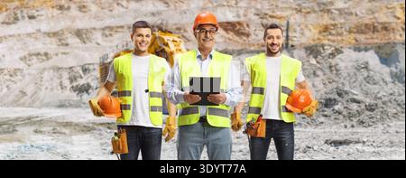 Workers in safety vests and hard hats at an open-pit mine Stock Photo