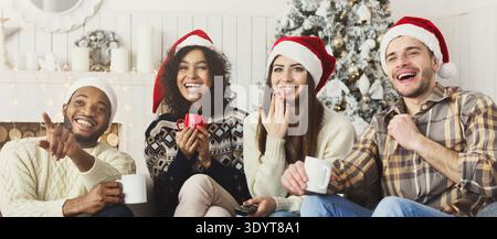 Friends watching movie and having fun at Christmas eve. Stock Photo