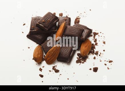 Broken dark chocolate bar and almonds isolated on white Stock Photo