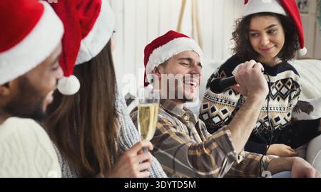 Happy friends singing together and playing on guitar Stock Photo