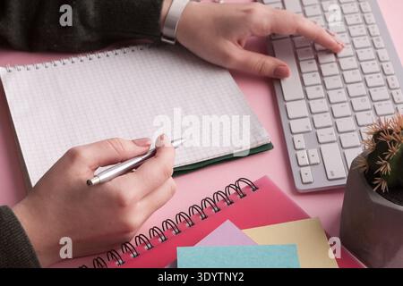 Woman's hands holding pen and spiral notepad Stock Photo