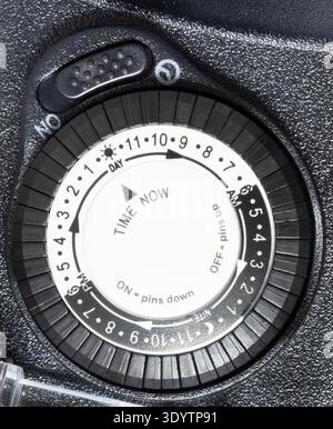 Controls on an outdoor electric timer seen up close that are often used to set when Christmas lights or decorations gone at at a house. Stock Photo