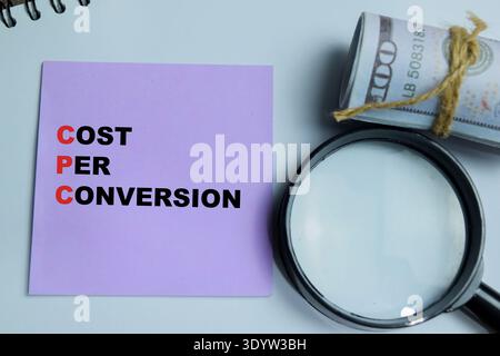 Concept of CPC - Cost Per Conversion write on sticky notes isolated on Wooden Table. For performance tracking, ROI optimization and pay per click stra Stock Photo