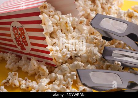 3D glasses and popcorn on red background Stock Photo