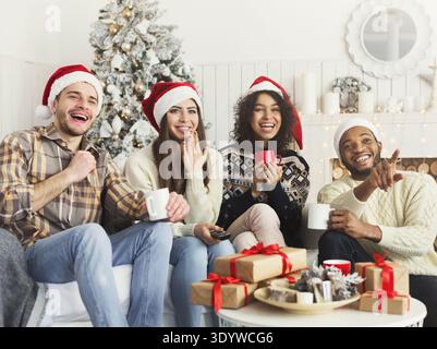 Friends watching movie and having fun at Christmas eve. Stock Photo