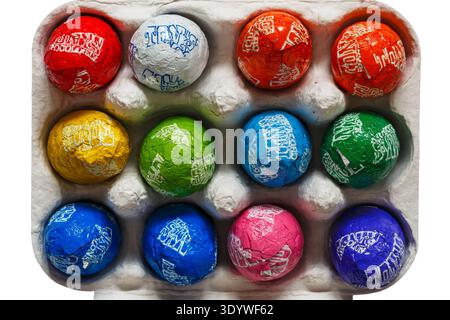 carton box of Tonys Tony's Chocolonely egg-star special coloured eggs opened to show contents set on white background Stock Photo