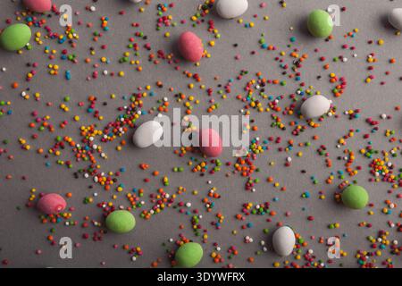 Various sweets and colorful sprinkles on gray table Stock Photo