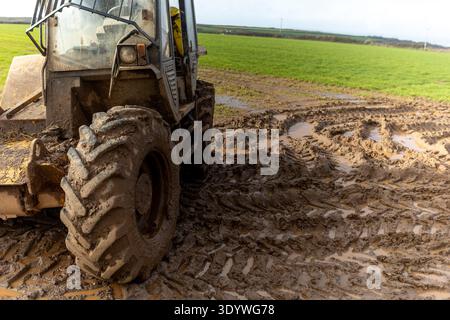 Farm vehicle in muddy Field after heavy rain Stock Photo