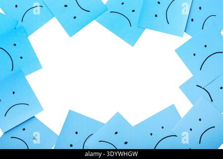Blue sticky notes with sad face drawing isolated on white background with clipping path. Top view. Design element. Stock Photo