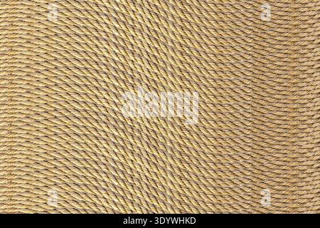This intricately woven natural fiber rope displays a warm, tan hue that elegantly captures light. Its unique twisted texture invites creativity, makin Stock Photo