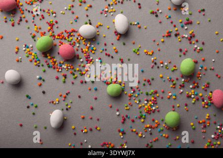 Various sweets and colorful sprinkles on gray table Stock Photo