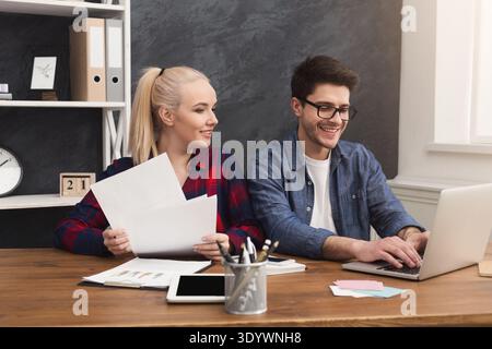 Couple of young colleagues work at modern office Stock Photo