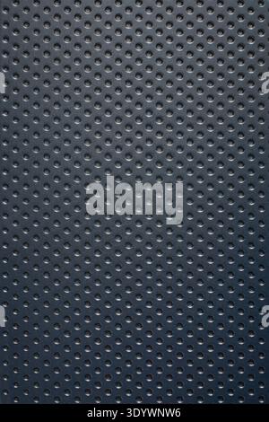 dark blue rubber gripped surface full frame texture, repeating dimpled dotted pattern on synthetic material with matte finish, uniform circular indent Stock Photo