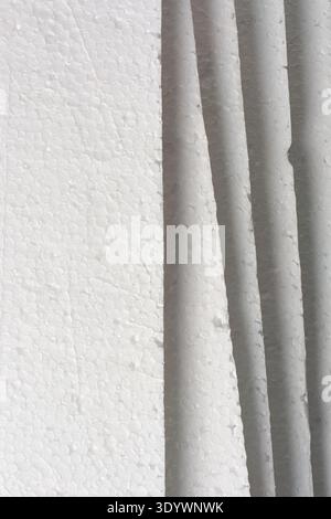 stacked white styrofoam boards in full frame texture, compressed polystyrene beads and visible layered edges material, packaging material background Stock Photo