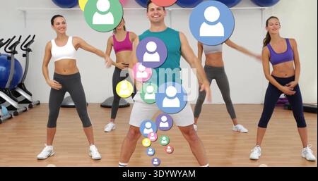 Leading male coach guiding four women in workout gear through aerobics in gym, overlaying avatars Stock Photo