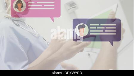 Reviewing two docs checking chats on tablet in clinic in scrubs with stethoscope and chat overlays Stock Photo