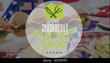 Displaying translucent ORGANIC FOOD badge over red-and-white picnic tablecloth with sliders, flags Stock Photo