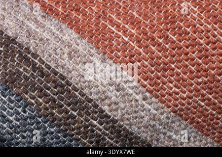 Macro close-up of woven textile fabric with diagonal stripes in brown, beige and cream tones showing detailed fibers and soft fabric texture. Stock Photo