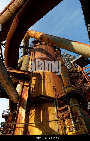 Rusty Tower Structure. Old Rusted Tower Featuring Intricate Scaffolding And Sharp Diagonal Metal Beams Stock Photo