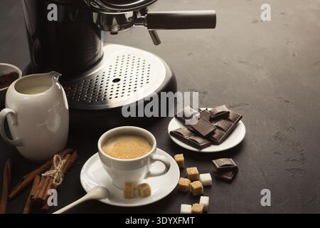 Coffee cup and sweets on black table Stock Photo