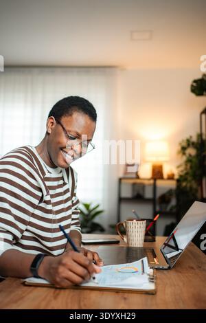 Happy woman working on documents in home office Stock Photo