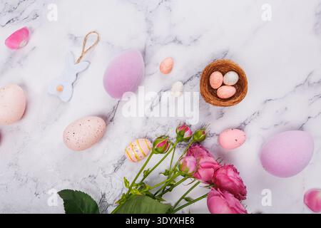Easter Eggs and Roses with Bunny Ornament on Marble Stock Photo