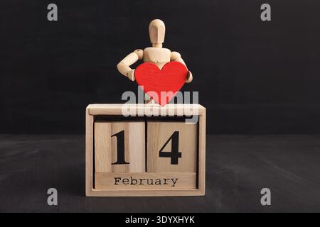 Wooden mannequin with red paper heart Stock Photo