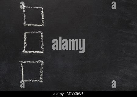 Empty checkboxses drawn with chalk on black background Stock Photo