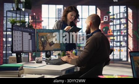 Workers in office use CAD software to design a house interior, providing a user interface for virtual home planning. Team of developers creating architectural layout and adjustments. Camera A. Stock Photo