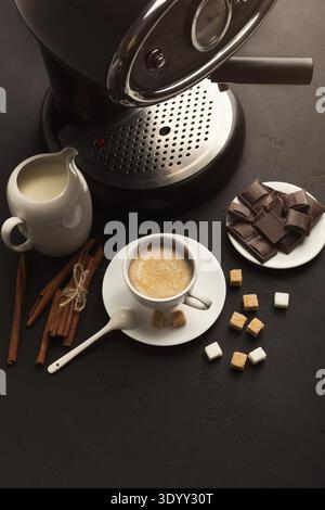 Coffee cup and sweets on black table Stock Photo