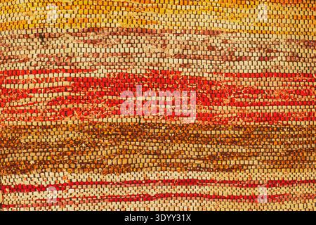 Detailed macro texture of horizontal woven rug in warm autumn colors Stock Photo