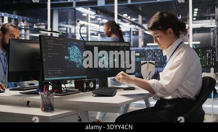 Server room admin holding clipboard, following procedures to evaluate system performance metrics. Data center employee going over maintenance fixes list, running diagnostics on equipment, camera A Stock Photo