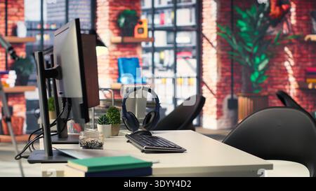 Digital workstation features multiple PC monitors running artificial intelligence and deep learning code. Empty high tech space supports cloud computing, data science and self learning systems. Stock Photo