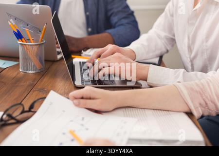 Businesspeople working on laptop in office Stock Photo