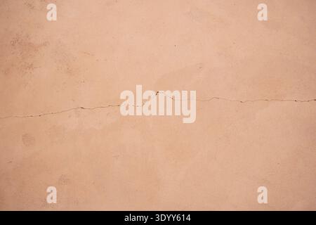 Terracotta wall texture with delicate crack, warm abstract background Description Stock Photo