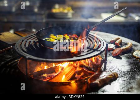 Cooking over an open fire, in an iron pan, rustic, Styria, Austria, Europe Stock Photo