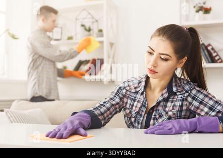 Young couple wiping dust together Stock Photo