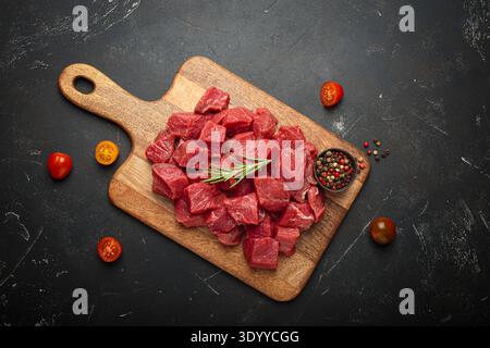 Raw beef cubes on a wooden board Stock Photo