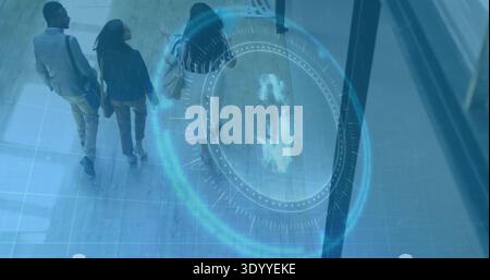 Walking three coworkers wearing business clothes, moving across tiles in lobby, with blue hologram Stock Photo