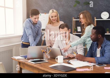 Company coworkers discussing ideas in office Stock Photo